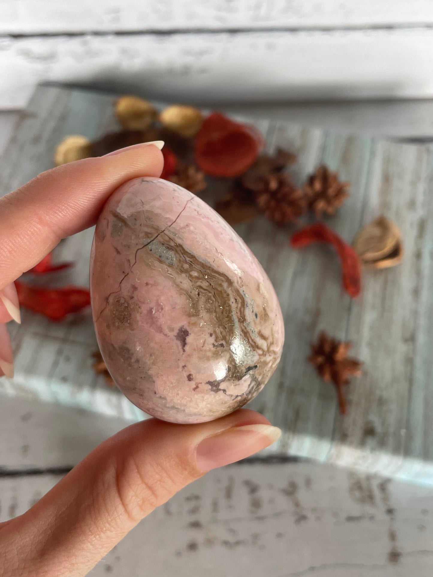Rhodochrosite egg with holder