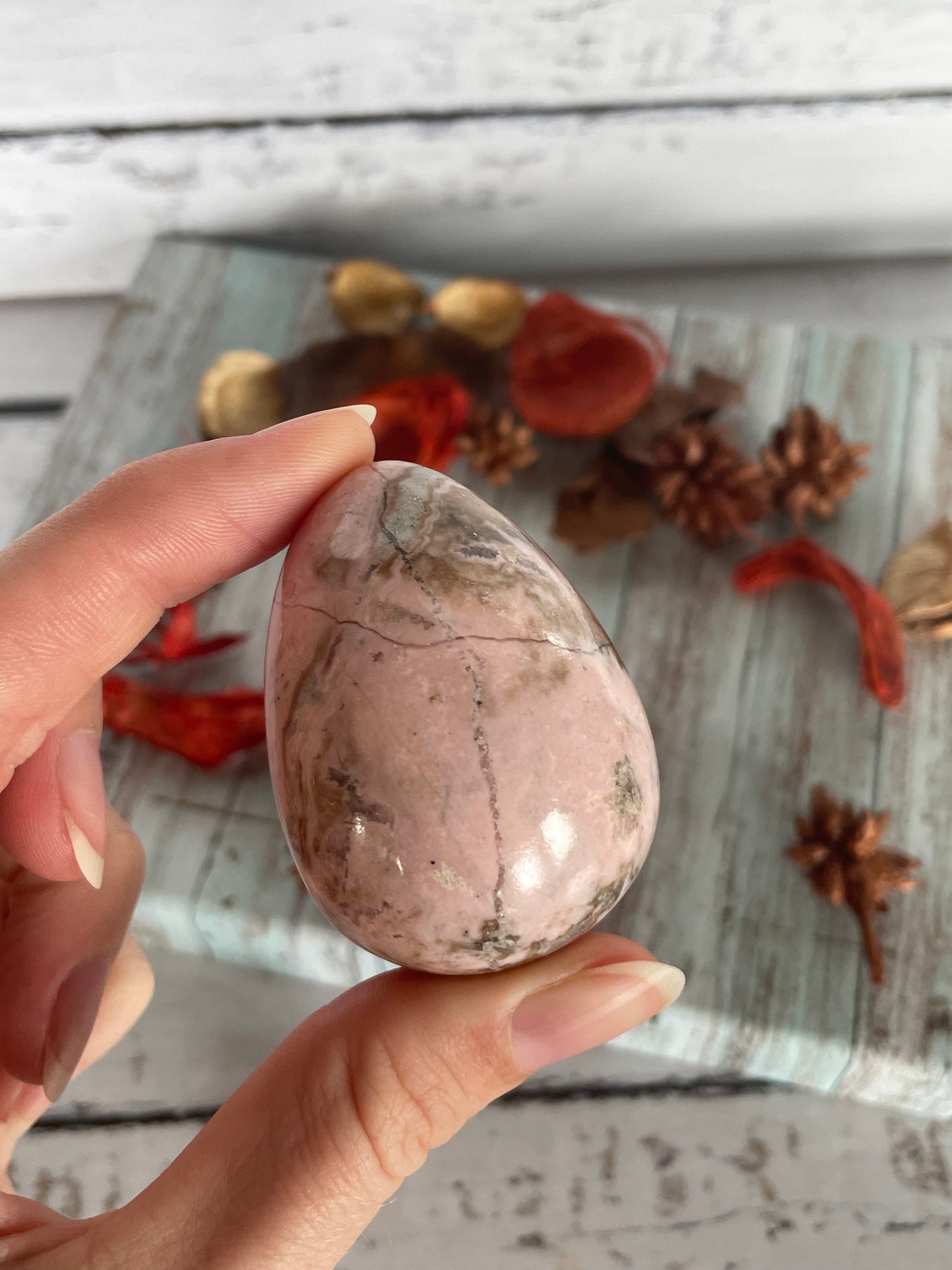 Rhodochrosite egg with holder