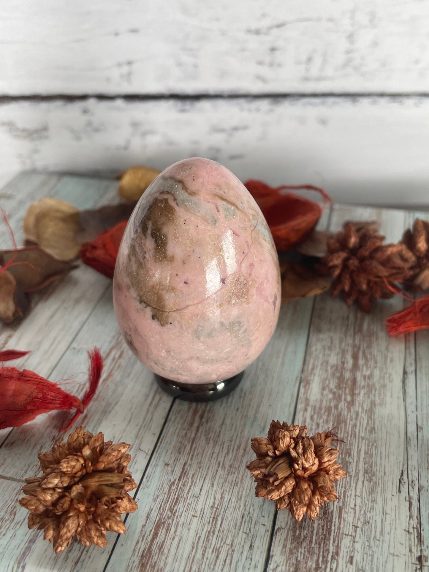 Rhodochrosite egg with holder
