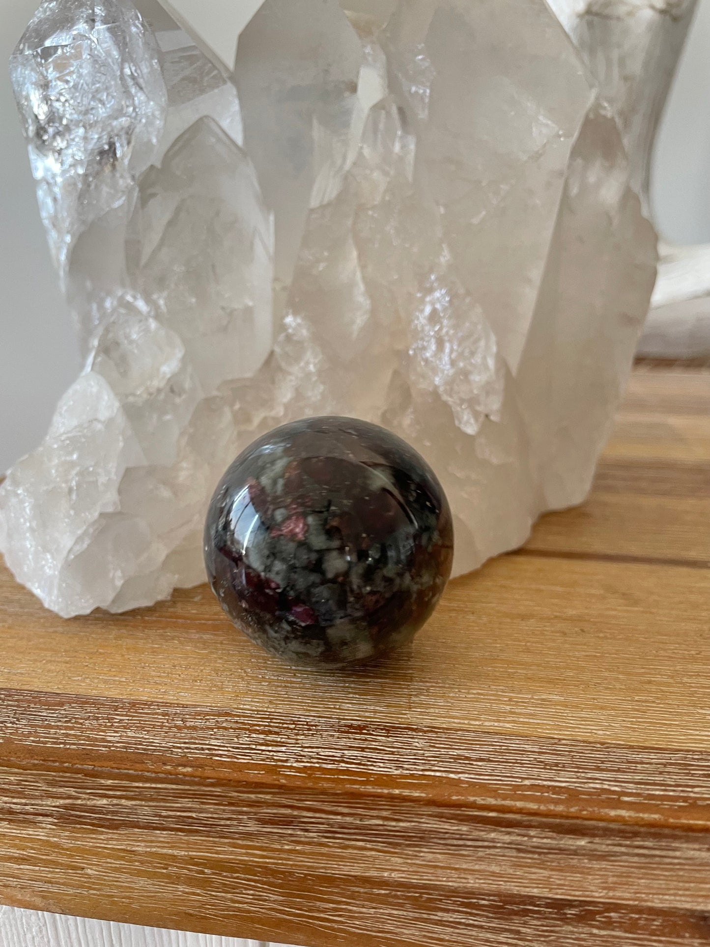 Eudialyte Sphere includes wooden holder