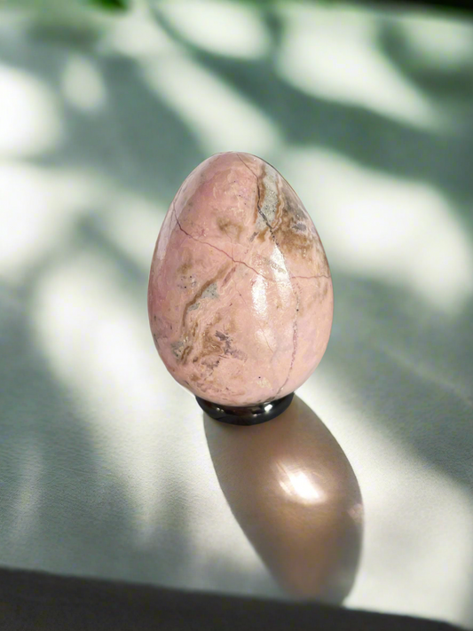 Rhodochrosite egg with holder