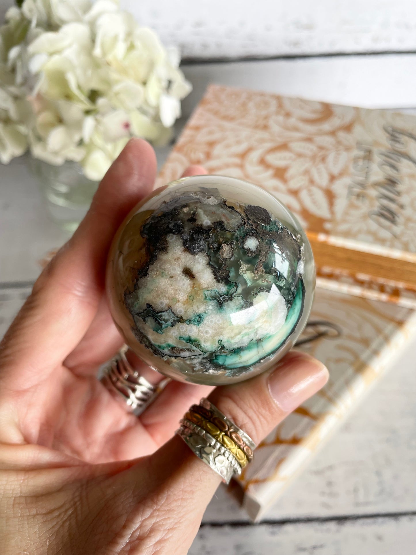 Green Flower Agate Sphere includes wooden holder