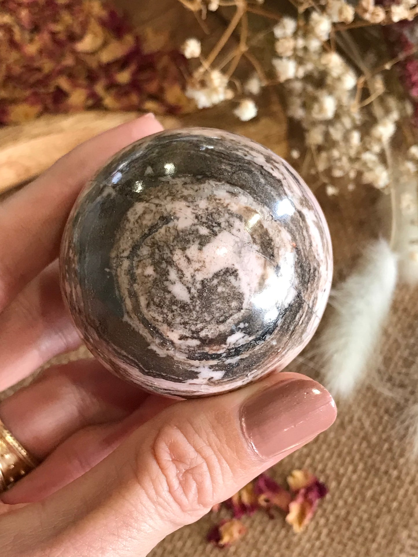 Rhodochrosite Sphere Includes Wooden Holder